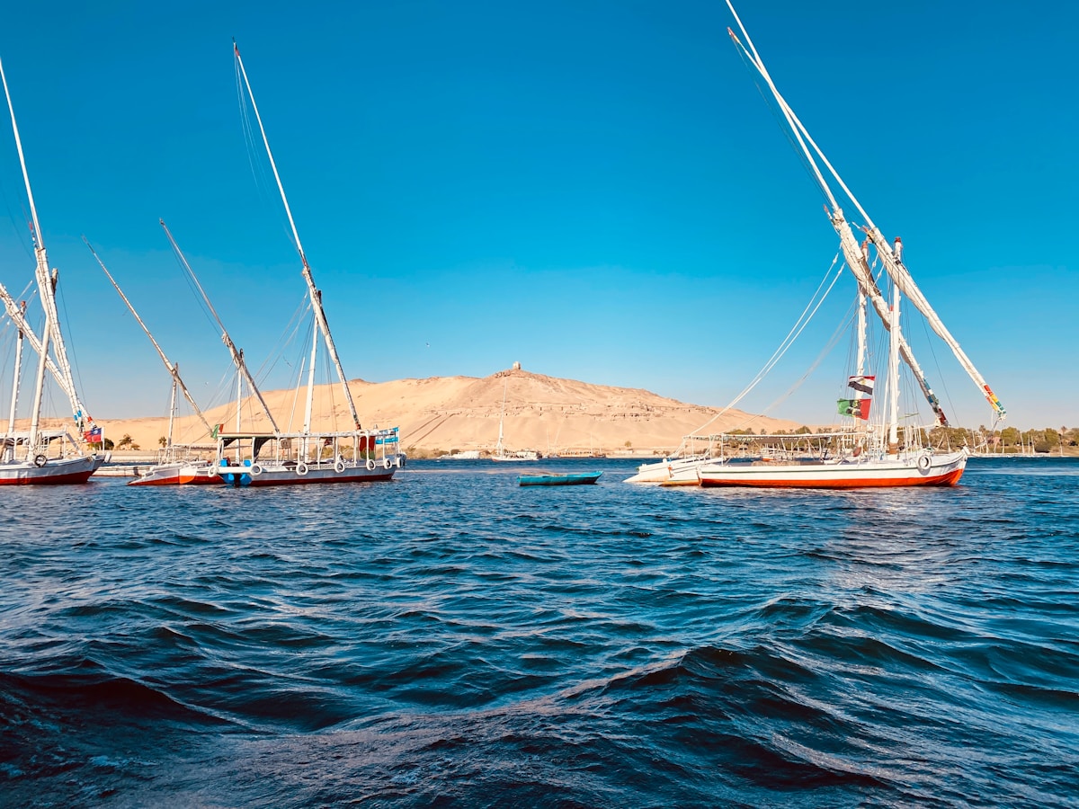 Traditional felucca sailing boat on the Nile at sunset near Aswan