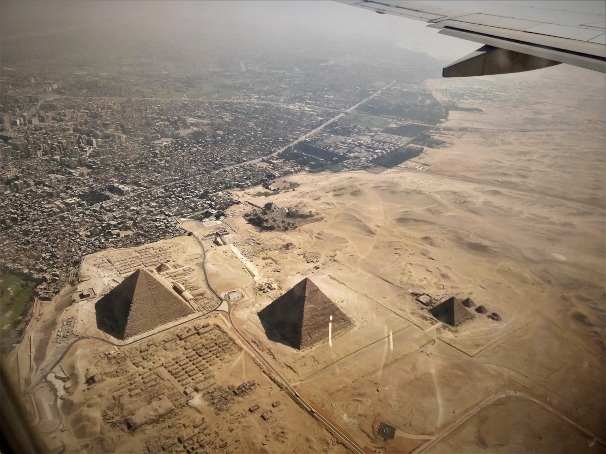 The pyramids of Giza rising above the Cairo skyline at dusk