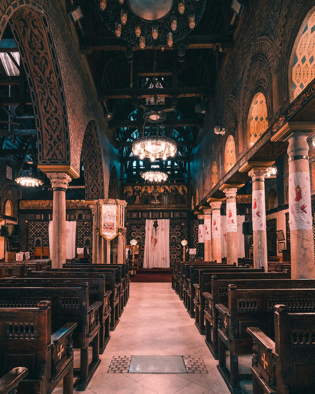 The interior of the Hanging Church in Coptic Cairo, showing ornate wooden screens and carved pillars